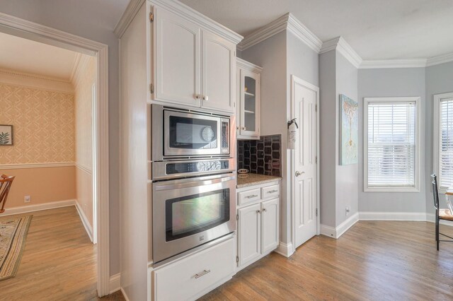 5784 Rock Springs Rd, Smyrna, TN 37167 - kitchen with stainless steel appliances, white cabinets, light wood finished floors, and ornamental molding