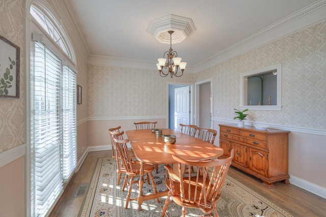 5784 Rock Springs Rd, Smyrna, TN 37167 - dining area with wood finished floors, crown molding, a chandelier, wallpapered walls, and wainscoting