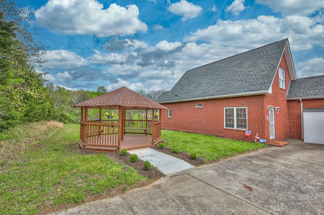 5784 Rock Springs Rd, Smyrna, TN 37167 - view of side of home featuring a gazebo, brick siding, a shingled roof, and a lawn