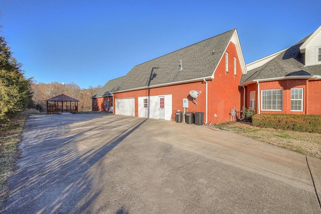 5784 Rock Springs Rd, Smyrna, TN 37167 - view of property exterior featuring brick siding, roof with shingles, a gazebo, and driveway