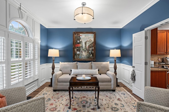 1013 Nealcrest Cir, Spring Hill, TN 37174 - living area with a wainscoted wall, wood finished floors, a decorative wall, and crown molding