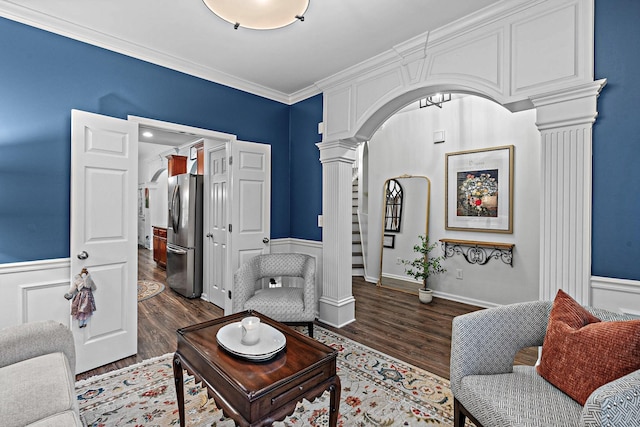 1013 Nealcrest Cir, Spring Hill, TN 37174 - living room with ornate columns, arched walkways, wood finished floors, wainscoting, and ornamental molding