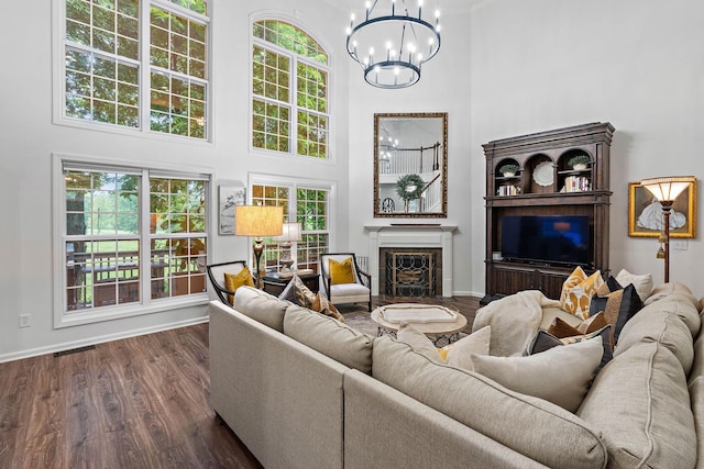 1013 Nealcrest Cir, Spring Hill, TN 37174 - living room with a high ceiling, a chandelier, dark wood-style flooring, a fireplace, and baseboards