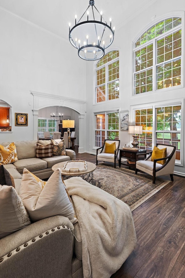 1013 Nealcrest Cir, Spring Hill, TN 37174 - living area featuring a chandelier, a high ceiling, wood finished floors, plenty of natural light, and crown molding