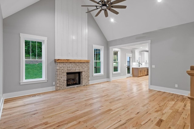 264 Goose Creek Cir, Soddy Daisy, TN 37379 - unfurnished living room featuring high vaulted ceiling, ceiling fan, light wood finished floors, a brick fireplace, and recessed lighting