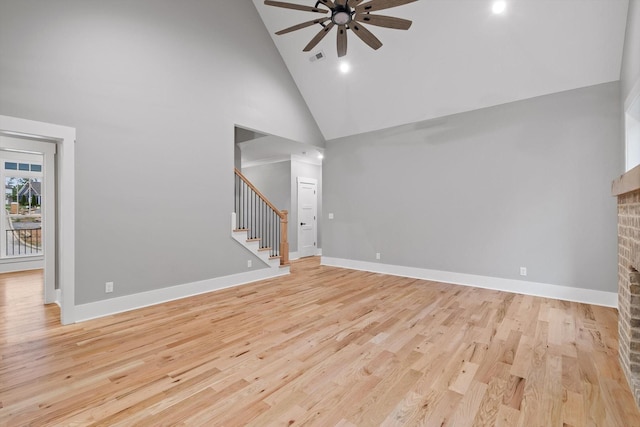 264 Goose Creek Cir, Soddy Daisy, TN 37379 - unfurnished living room featuring high vaulted ceiling, a ceiling fan, stairway, light wood-style flooring, and a brick fireplace
