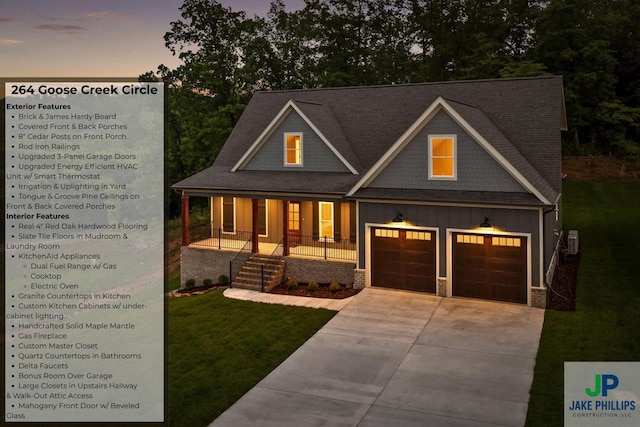 264 Goose Creek Cir, Soddy Daisy, TN 37379 - view of front of house with board and batten siding, covered porch, concrete driveway, a lawn, and a shingled roof