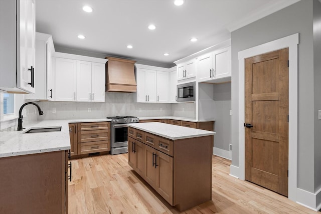264 Goose Creek Cir, Soddy Daisy, TN 37379 - kitchen featuring premium range hood, appliances with stainless steel finishes, a sink, light stone counters, and backsplash