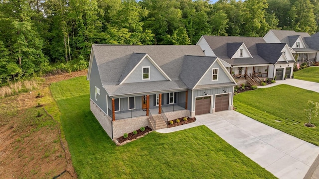 264 Goose Creek Cir, Soddy Daisy, TN 37379 - view of front of home featuring covered porch, concrete driveway, a garage, a front yard, and stairway