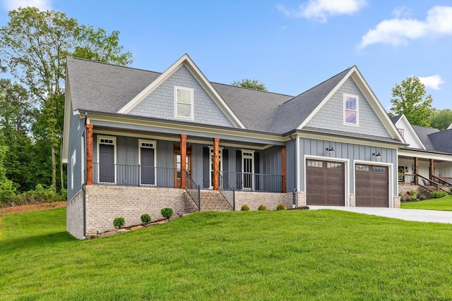 264 Goose Creek Cir, Soddy Daisy, TN 37379 - view of front facade with board and batten siding, covered porch, a front lawn, driveway, and brick siding