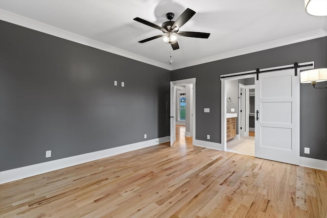 264 Goose Creek Cir, Soddy Daisy, TN 37379 - unfurnished bedroom with a barn door, light wood-style flooring, ornamental molding, baseboards, and a ceiling fan