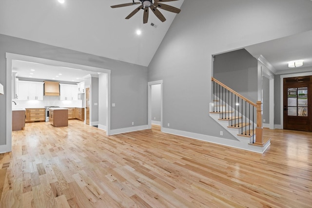 264 Goose Creek Cir, Soddy Daisy, TN 37379 - unfurnished living room featuring high vaulted ceiling, a ceiling fan, light wood-style flooring, stairs, and baseboards