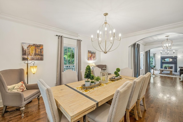 5432 Parker Branch Rd, Franklin, TN 37064 - dining room with a chandelier, arched walkways, ornamental molding, dark wood finished floors, and a fireplace