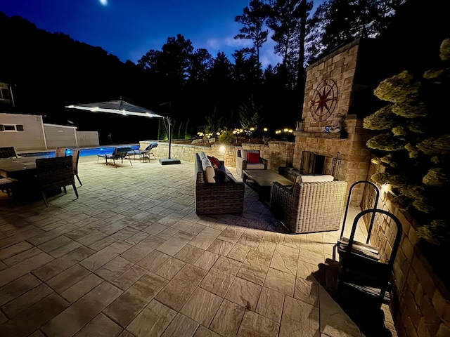 5432 Parker Branch Rd, Franklin, TN 37064 - patio at twilight featuring an outdoor stone fireplace