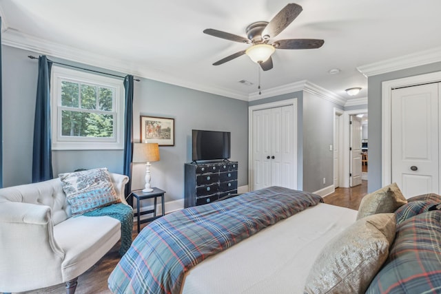 5432 Parker Branch Rd, Franklin, TN 37064 - bedroom featuring two closets, baseboards, wood finished floors, ornamental molding, and a ceiling fan