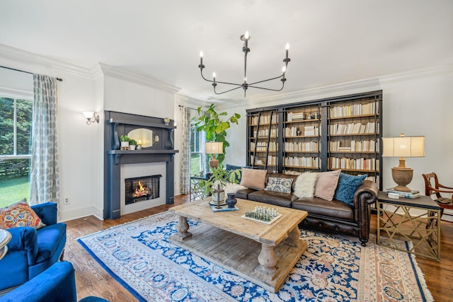 5432 Parker Branch Rd, Franklin, TN 37064 - living area with a chandelier, crown molding, wood finished floors, a glass covered fireplace, and baseboards