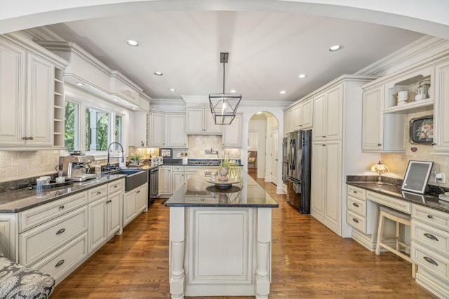 5432 Parker Branch Rd, Franklin, TN 37064 - kitchen with open shelves, arched walkways, freestanding refrigerator, a sink, and decorative backsplash