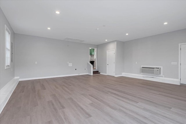 205 Jackson St, Cowan, TN 37318 - empty room with a wall mounted air conditioner, attic access, wood finished floors, baseboards, and recessed lighting