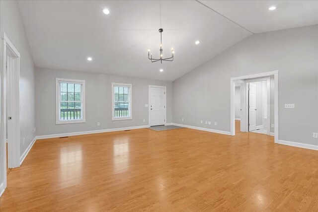 205 Jackson St, Cowan, TN 37318 - unfurnished living room with a chandelier, lofted ceiling, baseboards, light wood-style flooring, and recessed lighting