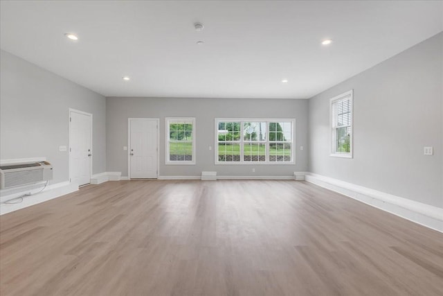 205 Jackson St, Cowan, TN 37318 - unfurnished living room featuring an AC wall unit, light wood-style flooring, recessed lighting, and baseboards