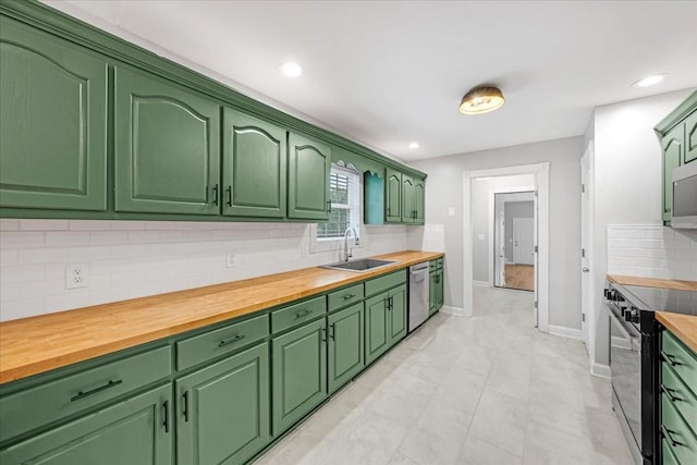205 Jackson St, Cowan, TN 37318 - kitchen with appliances with stainless steel finishes, a sink, butcher block counters, decorative backsplash, and recessed lighting