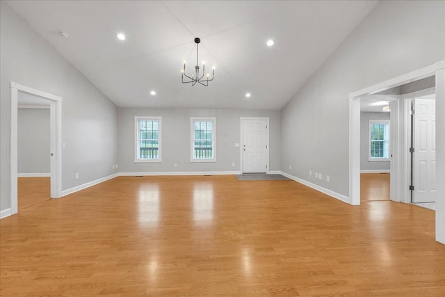 205 Jackson St, Cowan, TN 37318 - unfurnished living room with a chandelier, light wood-style flooring, baseboards, high vaulted ceiling, and recessed lighting
