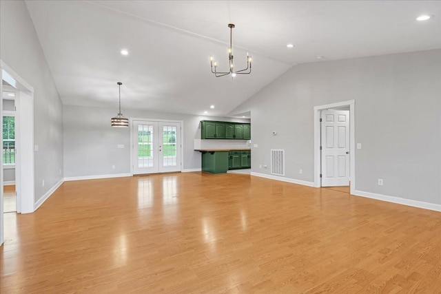 205 Jackson St, Cowan, TN 37318 - unfurnished living room featuring a chandelier, baseboards, light wood-type flooring, high vaulted ceiling, and recessed lighting