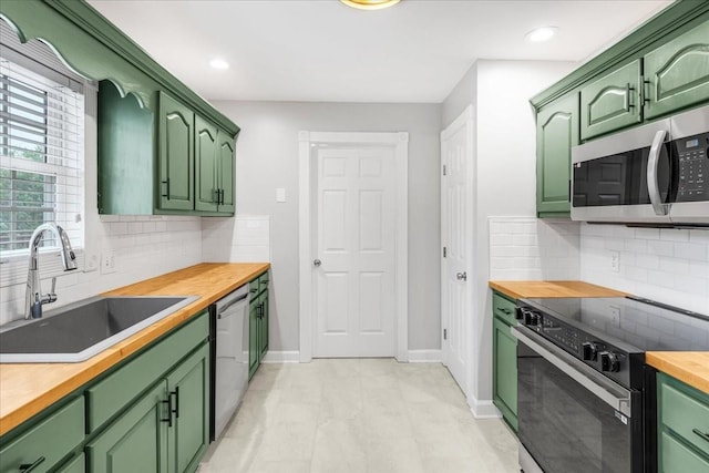 205 Jackson St, Cowan, TN 37318 - kitchen featuring stainless steel appliances, green cabinetry, butcher block countertops, a sink, and recessed lighting