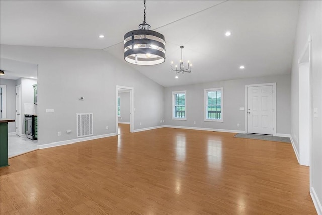 205 Jackson St, Cowan, TN 37318 - unfurnished living room with a chandelier, baseboards, wood finished floors, high vaulted ceiling, and recessed lighting