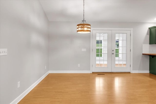 205 Jackson St, Cowan, TN 37318 - doorway featuring french doors, light wood finished floors, and baseboards