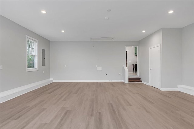 205 Jackson St, Cowan, TN 37318 - empty room featuring attic access, light wood-style floors, baseboards, recessed lighting, and electric panel