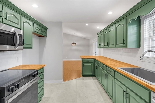 205 Jackson St, Cowan, TN 37318 - kitchen featuring range with electric stovetop, stainless steel microwave, a sink, vaulted ceiling, and tasteful backsplash