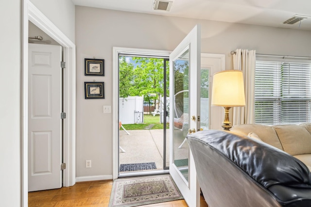 entryway with baseboards and wood finished floors