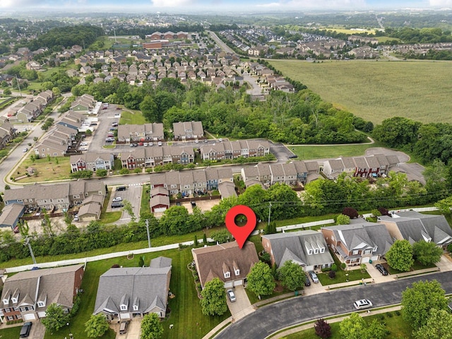 aerial view of property and surrounding area featuring nearby suburban area