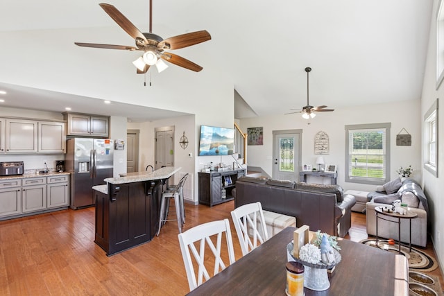 706 Kirbytown Rd, Lafayette, TN 37083 - dining room with ceiling fan, high vaulted ceiling, light wood-style floors, and stairs