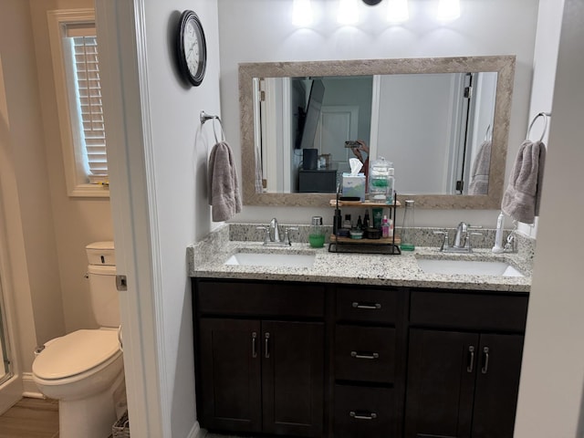 full bath with toilet and double vanity