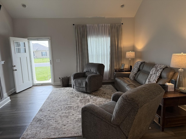 living room with wood finished floors, baseboards, recessed lighting, and lofted ceiling