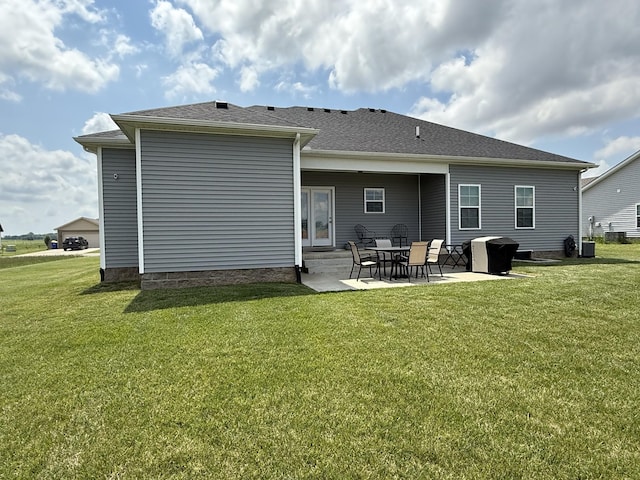 back of property with a patio area, a lawn, and entry steps