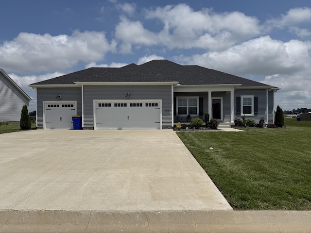 view of front of house featuring an attached garage, a front yard, and driveway