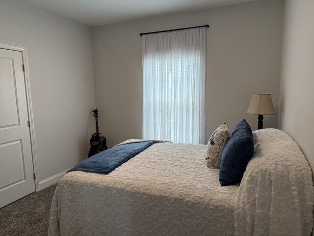carpeted bedroom featuring baseboards