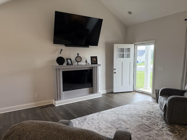 living area featuring wood finished floors, high vaulted ceiling, and baseboards