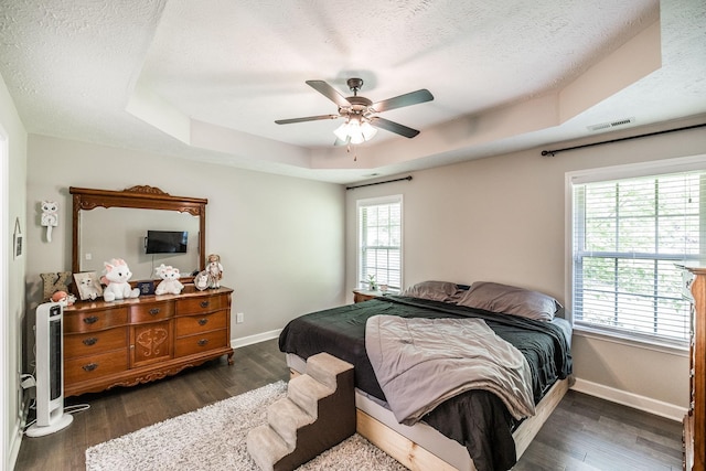 1461 Round Rock Dr, Murfreesboro, TN 37128 - bedroom featuring baseboards, a textured ceiling, dark wood-type flooring, and a tray ceiling