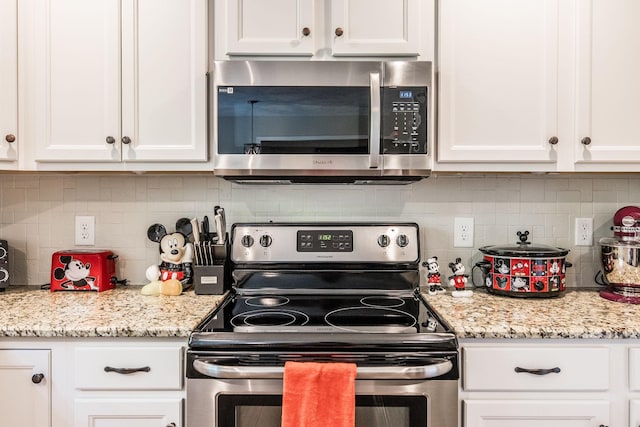 1461 Round Rock Dr, Murfreesboro, TN 37128 - kitchen featuring appliances with stainless steel finishes, white cabinets, backsplash, and light stone counters