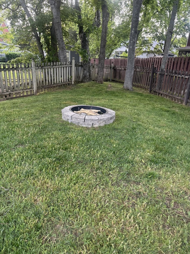 view of yard with a fire pit