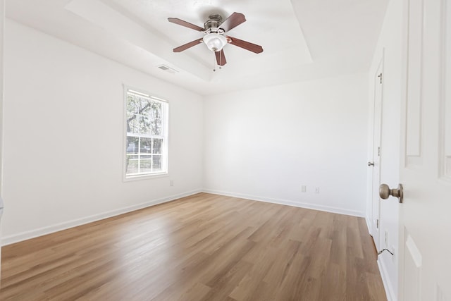 7004 Westfork Dr, Smyrna, TN 37167 - empty room with a tray ceiling, light wood finished floors, ceiling fan, and baseboards