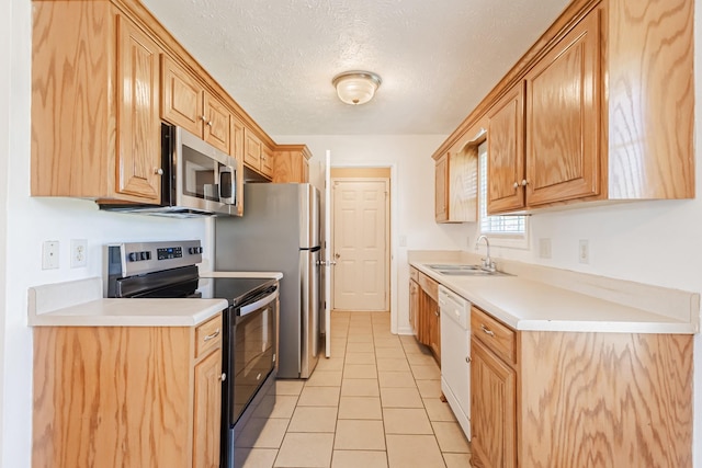 7004 Westfork Dr, Smyrna, TN 37167 - kitchen featuring stainless steel appliances, a sink, light tile patterned flooring, light countertops, and a textured ceiling