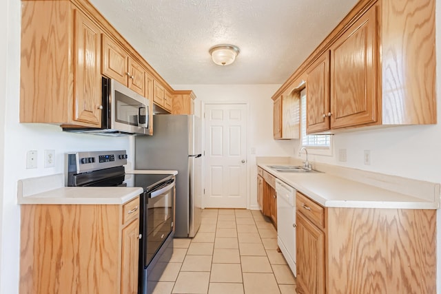 7004 Westfork Dr, Smyrna, TN 37167 - kitchen with appliances with stainless steel finishes, a sink, light tile patterned floors, light countertops, and a textured ceiling