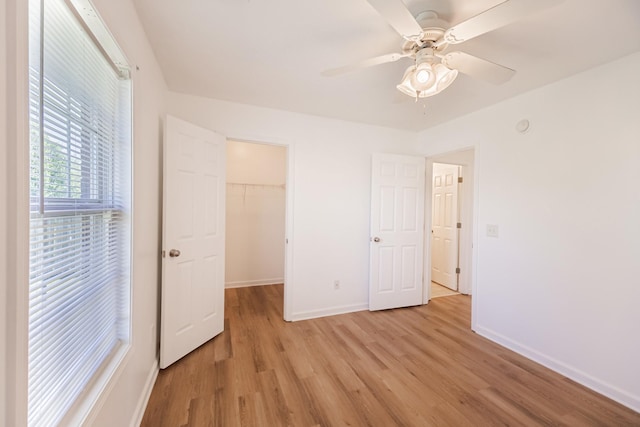 7004 Westfork Dr, Smyrna, TN 37167 - unfurnished bedroom with light wood-style floors, baseboards, a spacious closet, a closet, and a ceiling fan