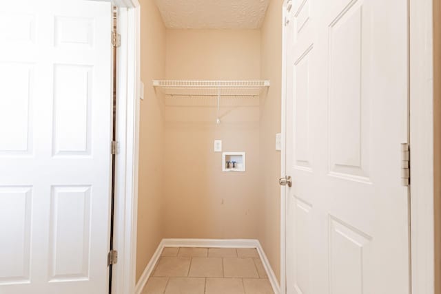 7004 Westfork Dr, Smyrna, TN 37167 - washroom featuring baseboards, washer hookup, light tile patterned flooring, and a textured ceiling