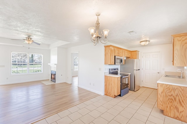 7004 Westfork Dr, Smyrna, TN 37167 - kitchen featuring appliances with stainless steel finishes, a sink, a ceiling fan, light countertops, and light tile patterned floors